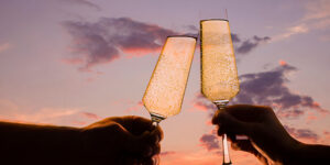 Man,And,Woman,Clink,Glasses,With,Champagne,At,Sunset